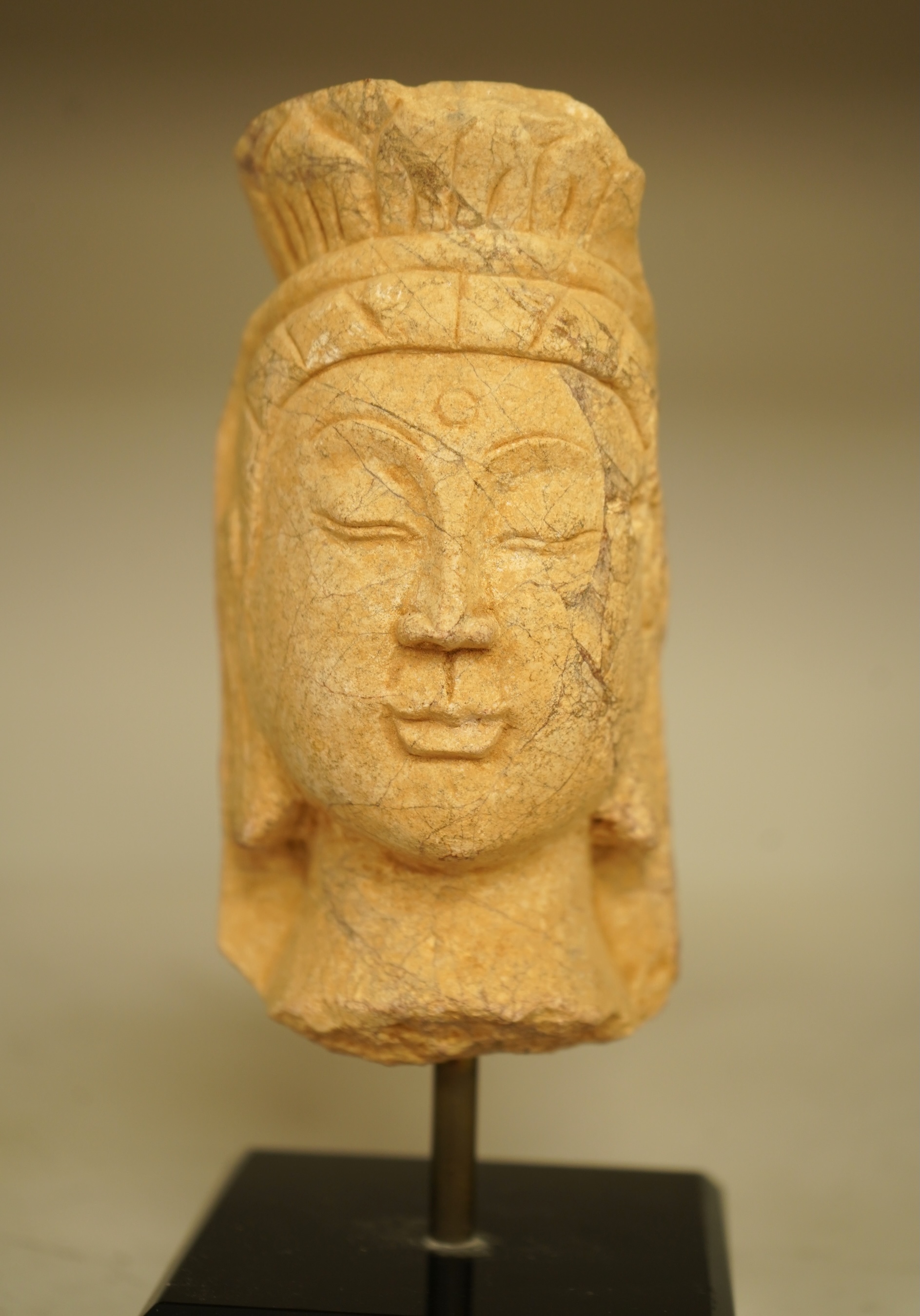 A composition bust of Bodhisattva, possibly Tibetan, on stand, 18cm high